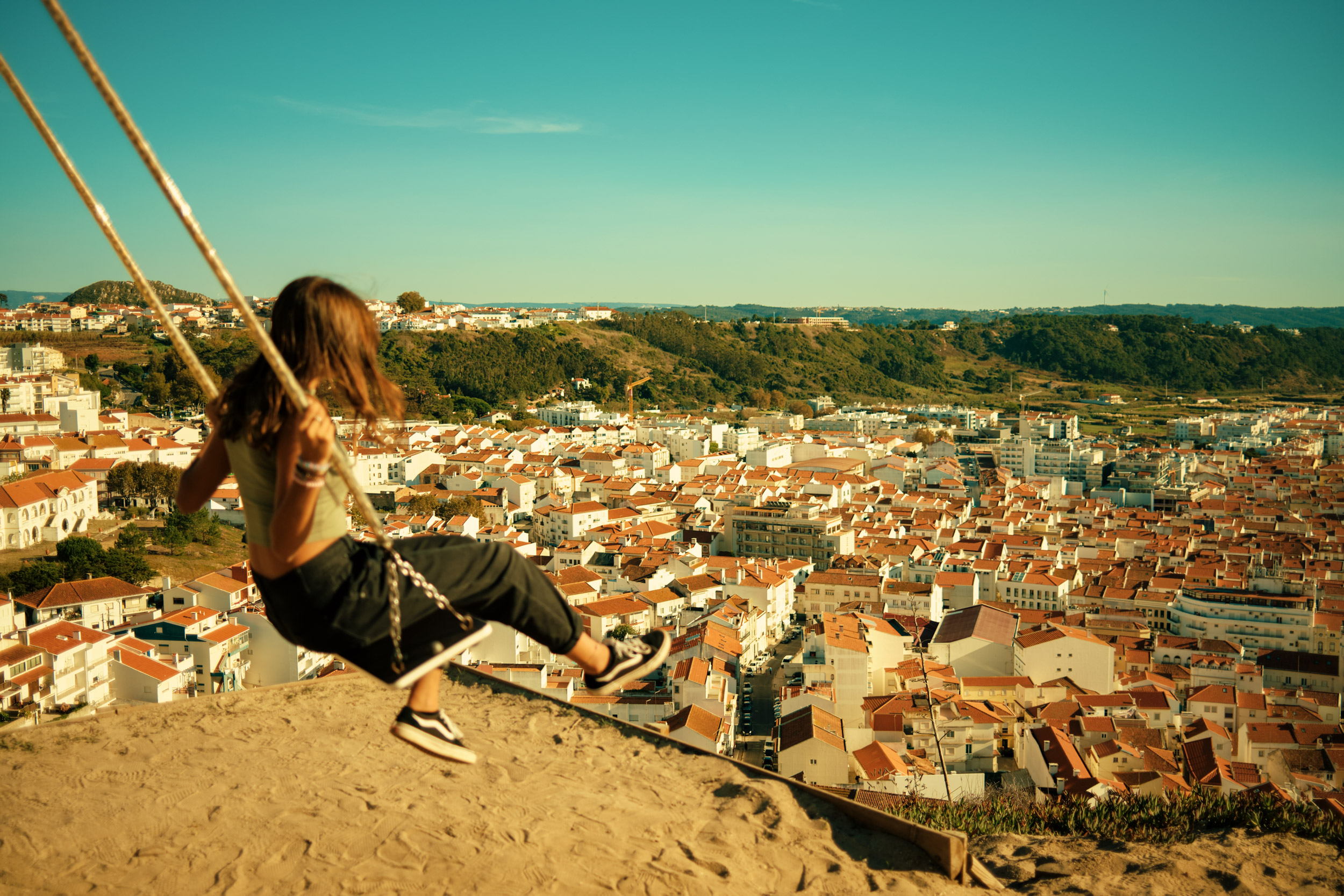 A-GIRL-SWINGS-OVER-THE-TOWN-OF-NAZARE-