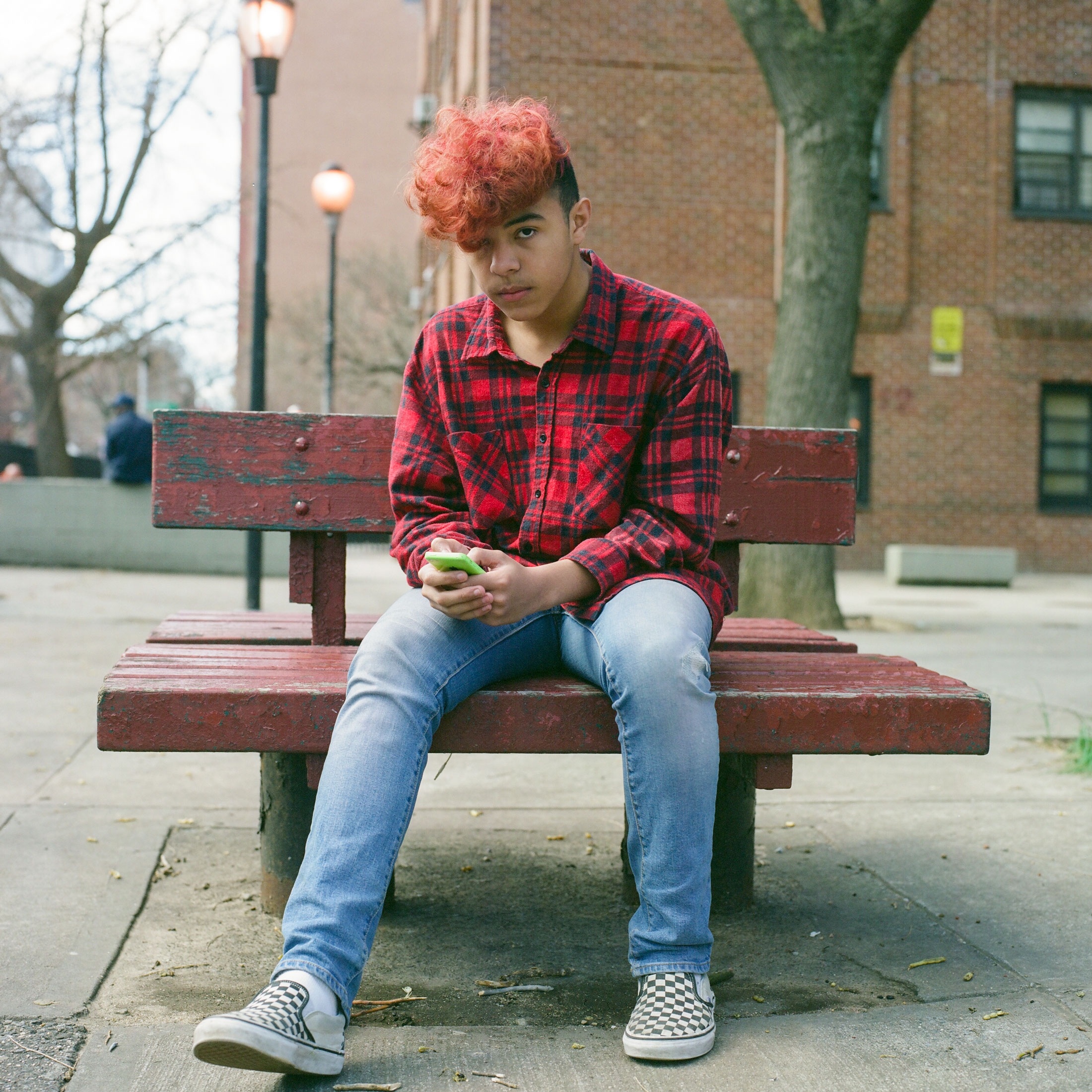 A-MEDIUM-FORMAT-STREET-PORTRAIT-OF-A-TEEN-ON-HIS-IPHONE