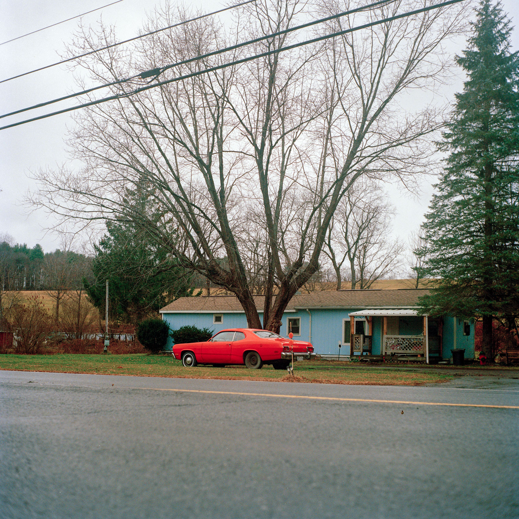 A vintage car sits in the front yard in upstate New York