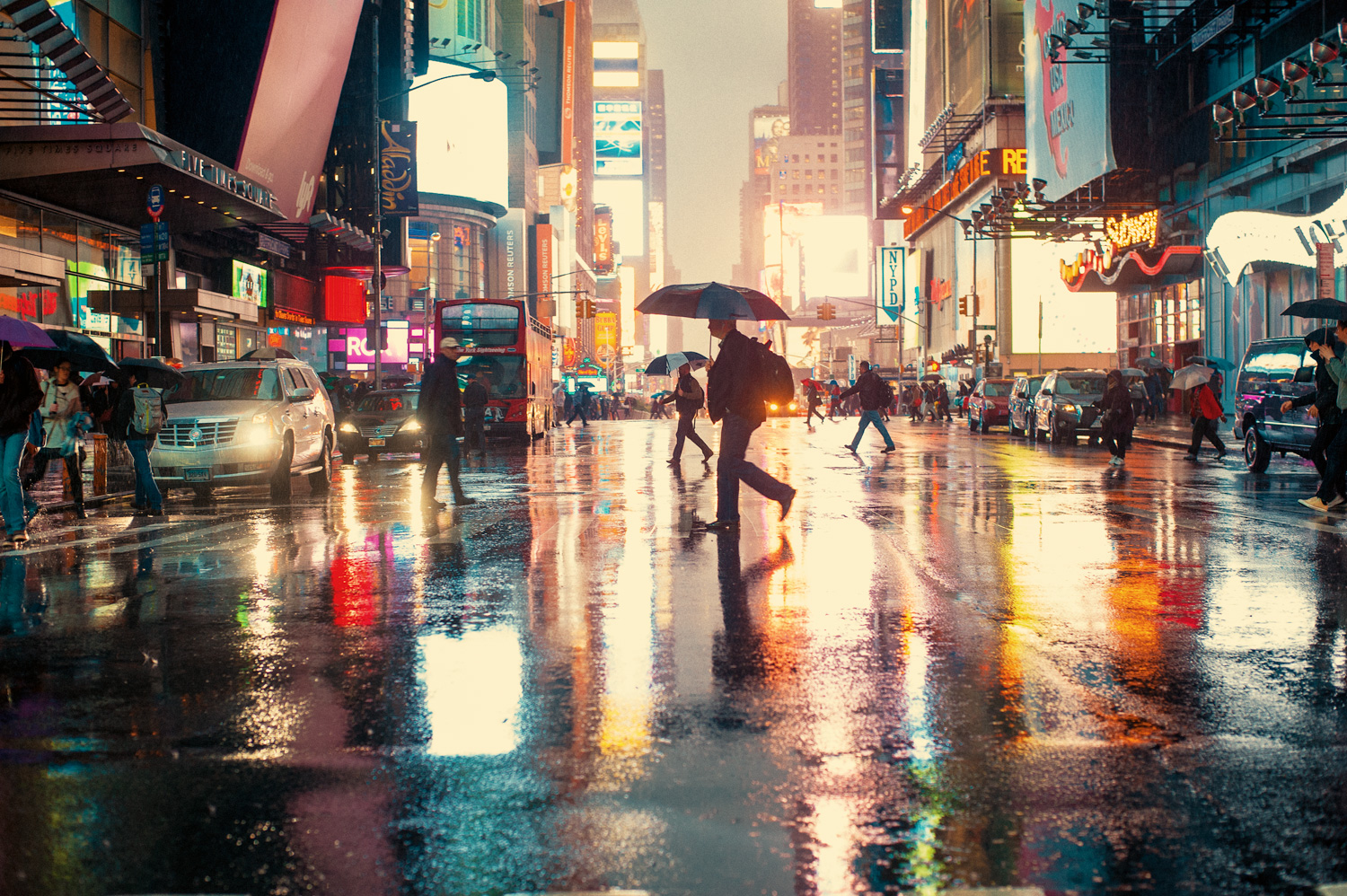 A guy crosses the street in Times Square during a heavy rainstorm, midtown, Manhattan, New York City