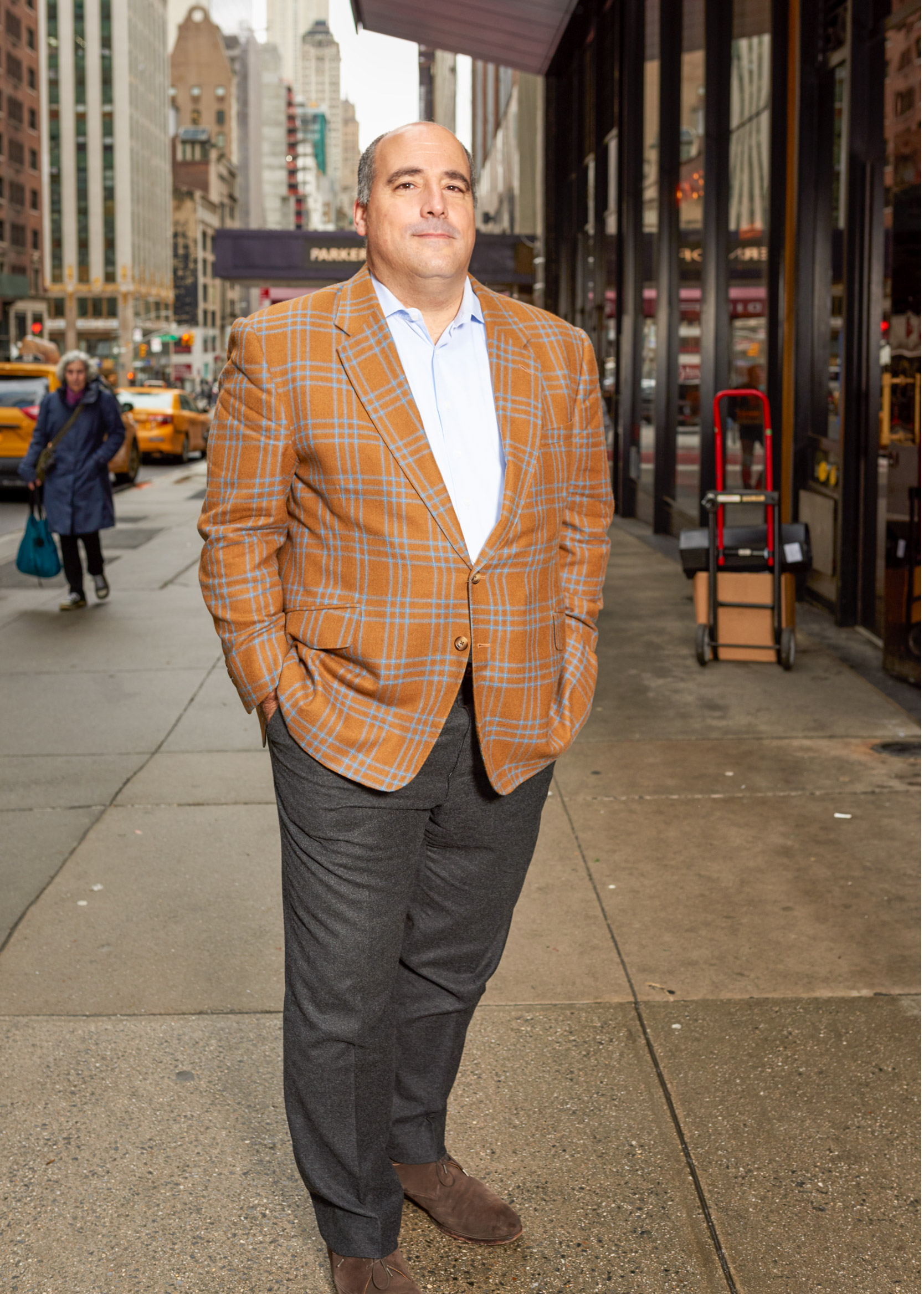 A REGULAR CUSTOMER WEARS A BESPOKE SUIT AND POSES ON 57TH STREET FOR CAD AND THE DANDY