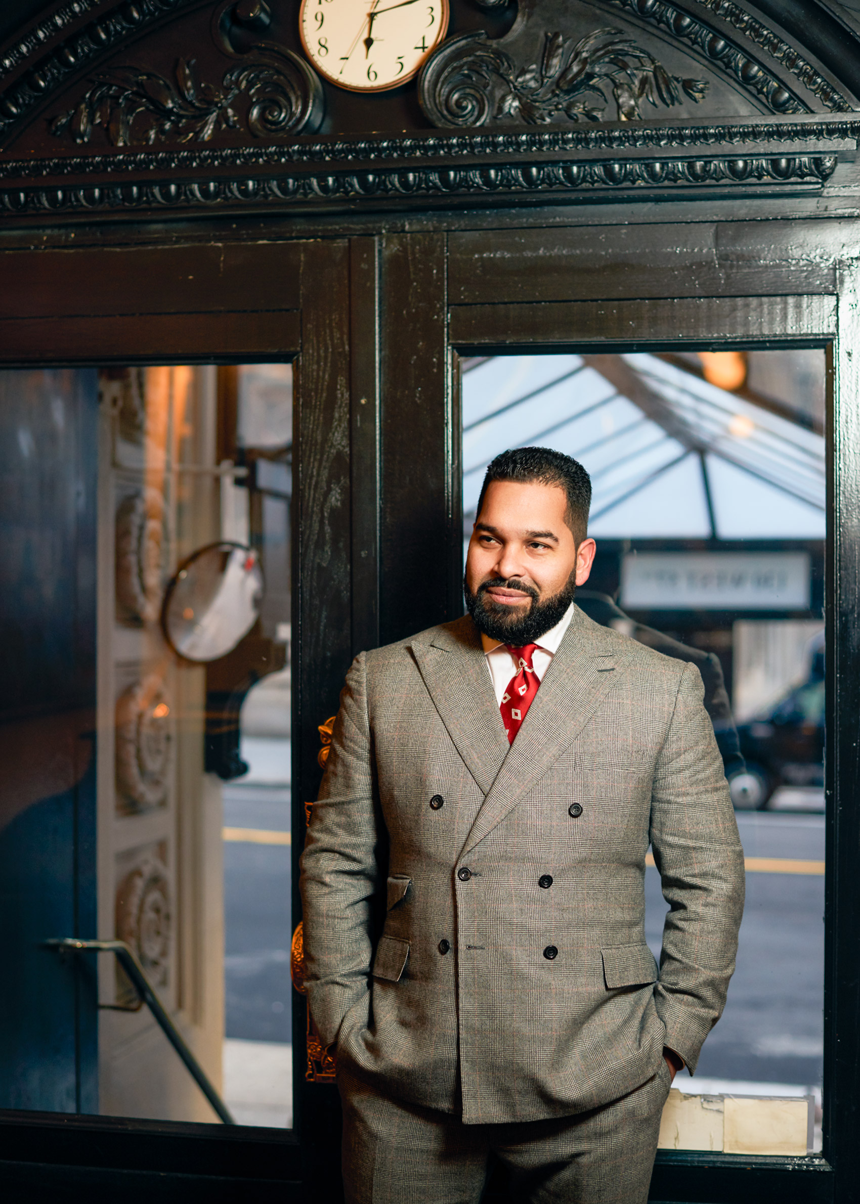 THE DOORMAN WEARS A  CUSTOM- MADE SUIT FOR CAD AND THE DANDY  