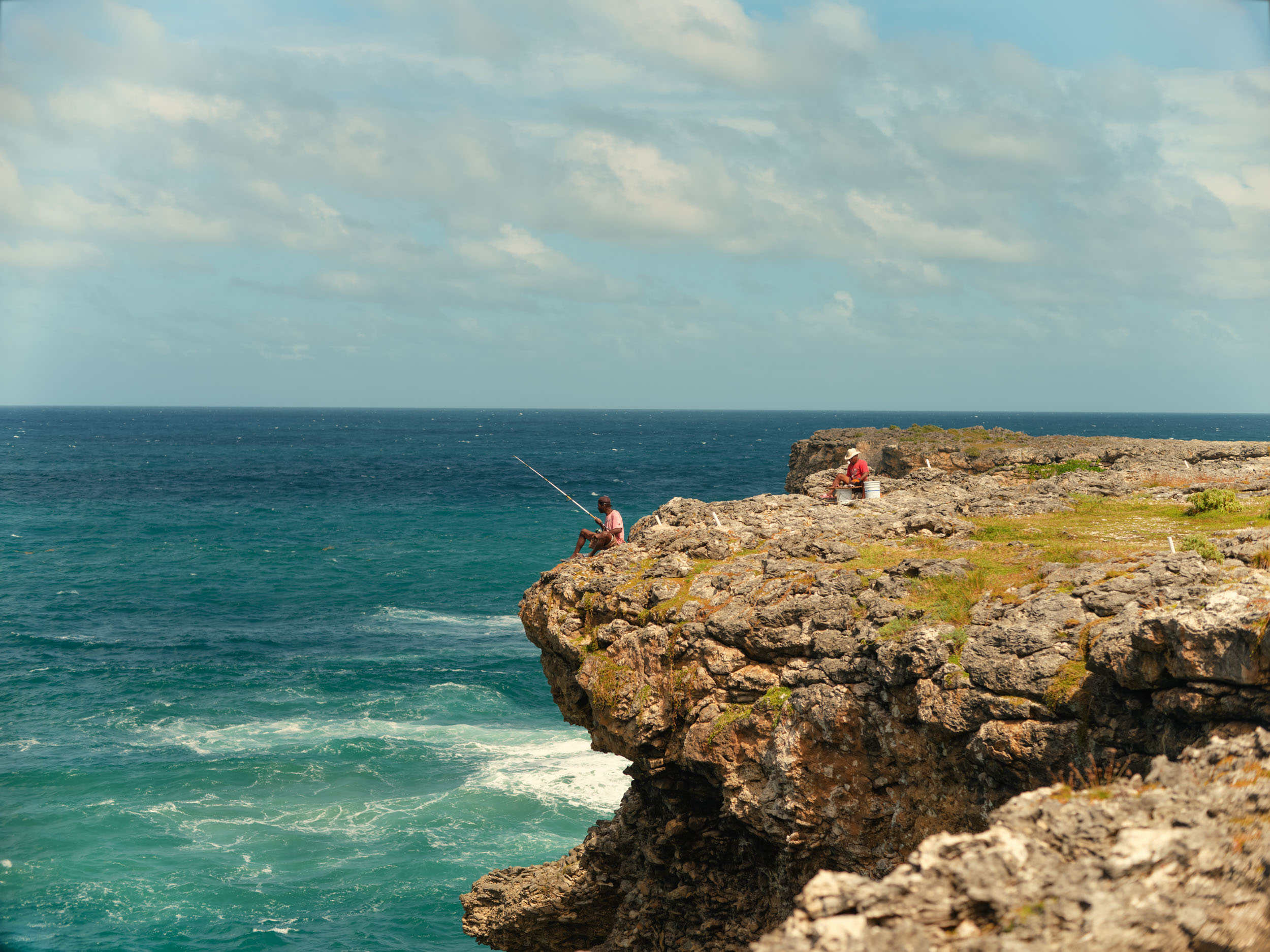 FISHERMAN-SIT-ON-EDGE-OF-A-CLIFF-NEAR-ANIMAL-FLOWER-COVE-BARBADOS_1