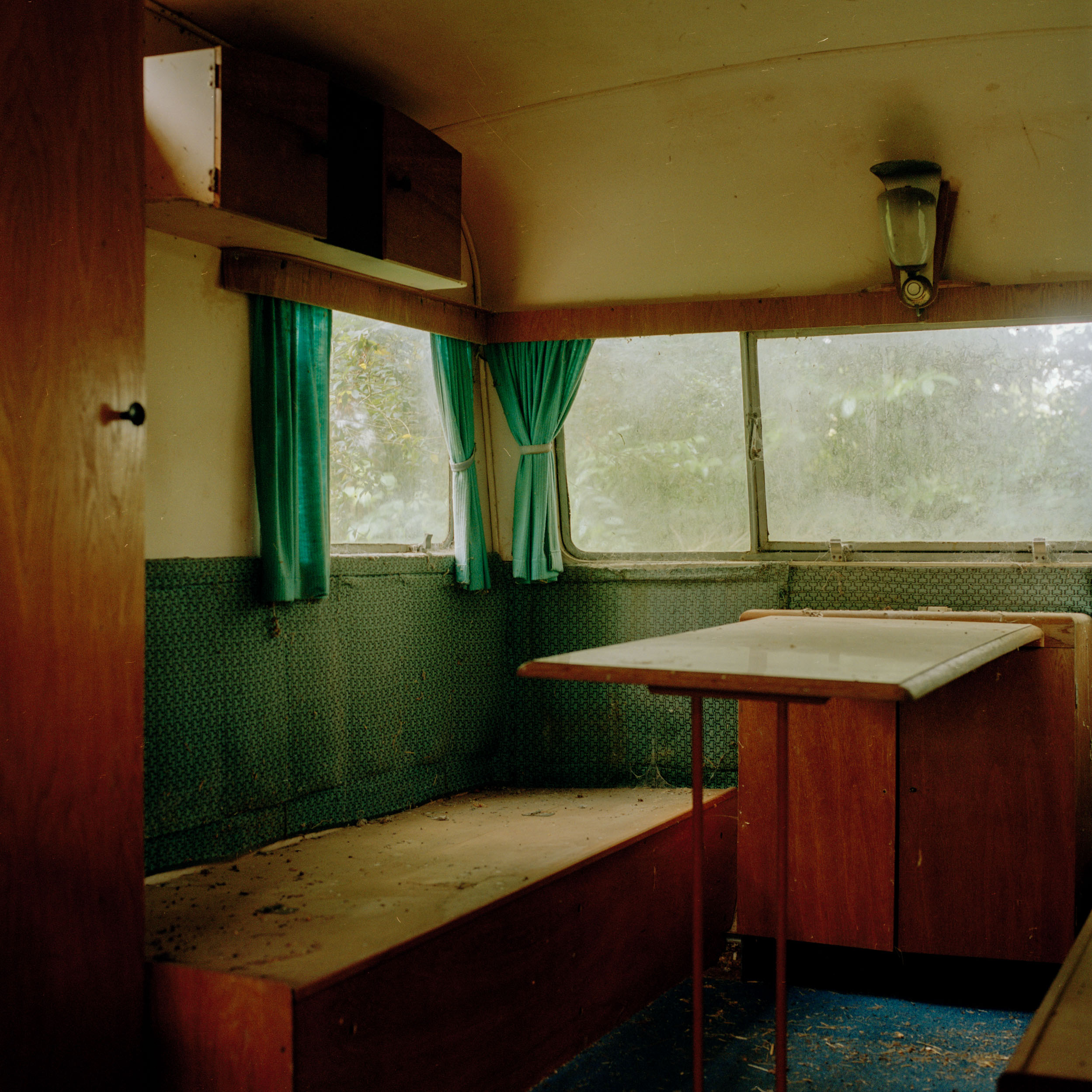 LIGHT-FILTERS-THROUGH-THE-DUSTY-MODLY-WINDOWS-OF-A-VINTAGE-ENGLISH-CARAVAN.JPG