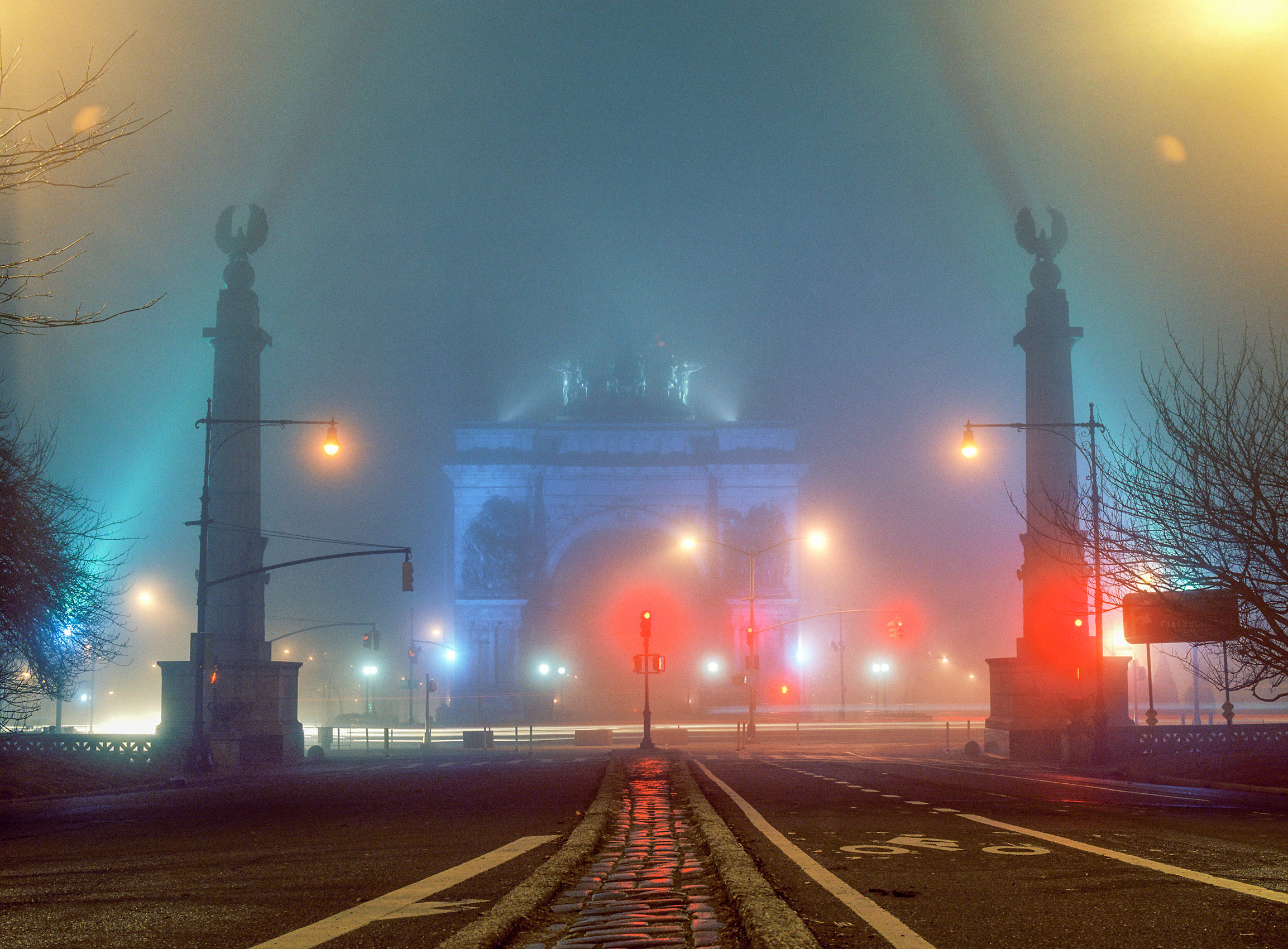 A-NIGHT-SHOT-OF-GRAND-ARMY-PLAZA-SHROUDED-BY-THE-MISTY-STREET-LIGHTS