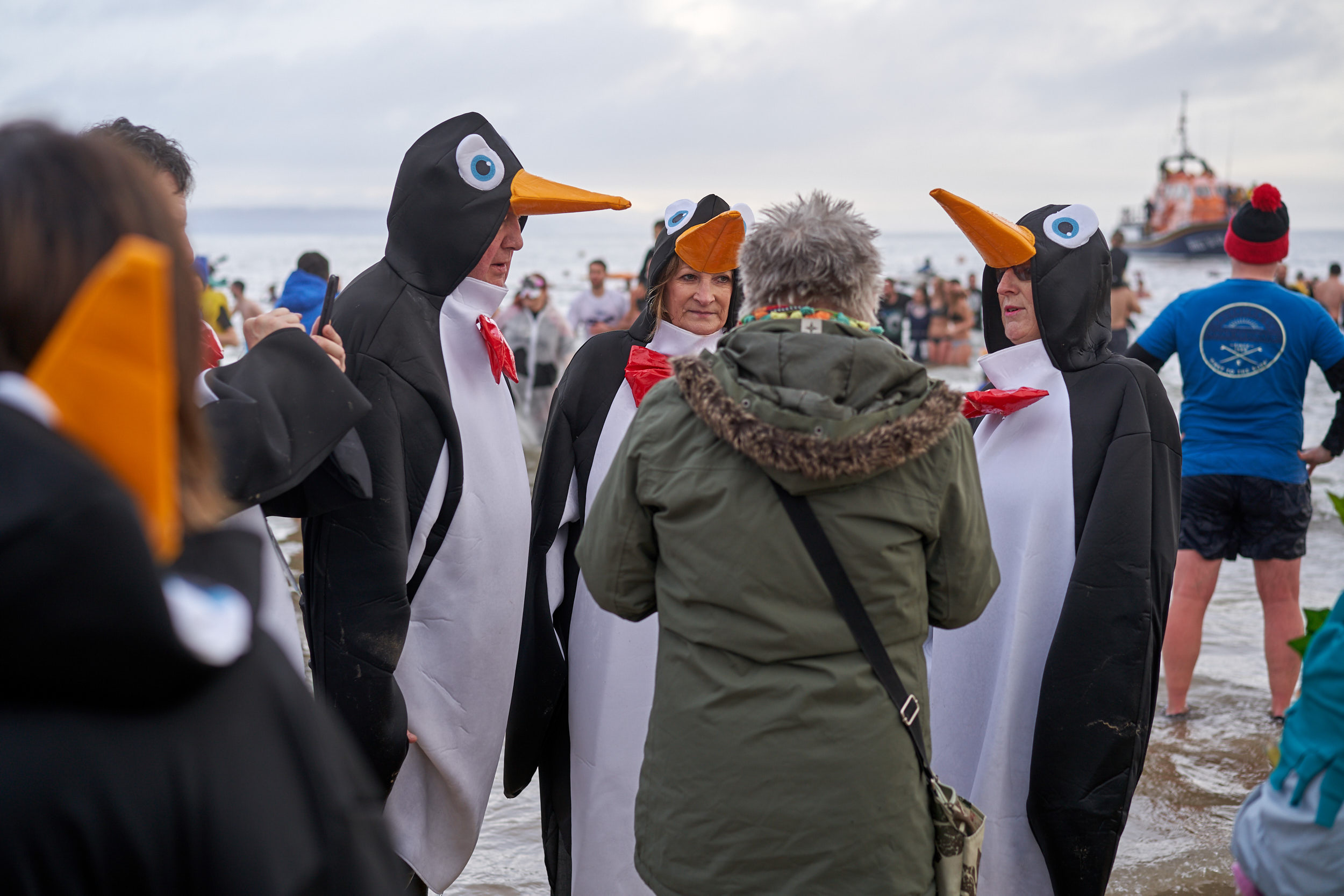 PARTICIPANTS POSE IN PENGUIN SUITS FOR A PHOTO DURING THE TENBY BOXING DAY SWIM