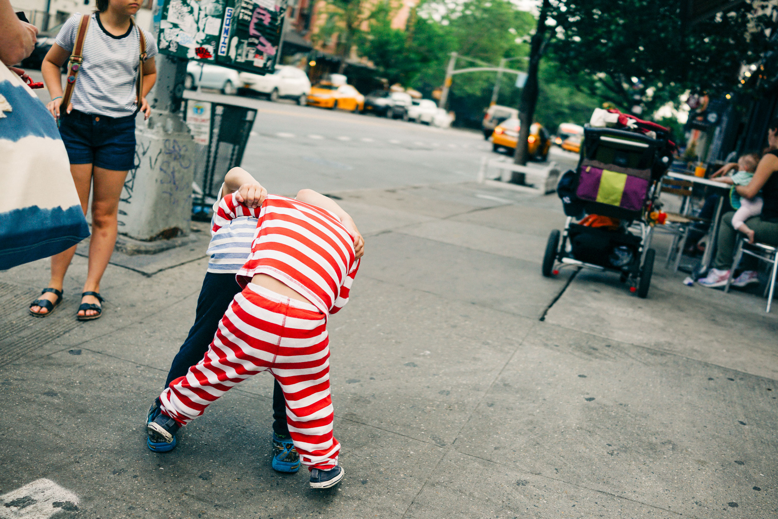 Two children play fight in the East Village of New York City in the summer of 2016. 