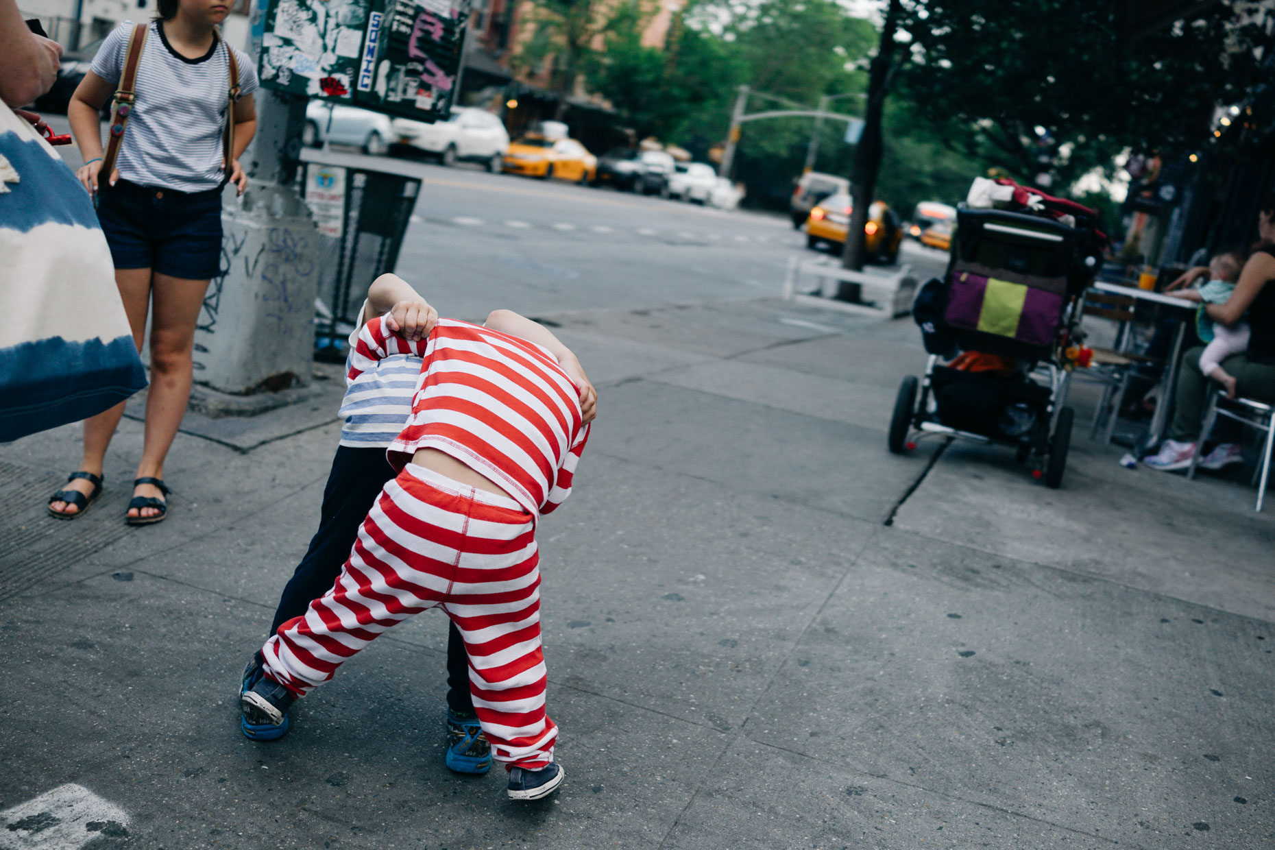 Two children play fight in the East Village of New York City in the summer of 2016. 