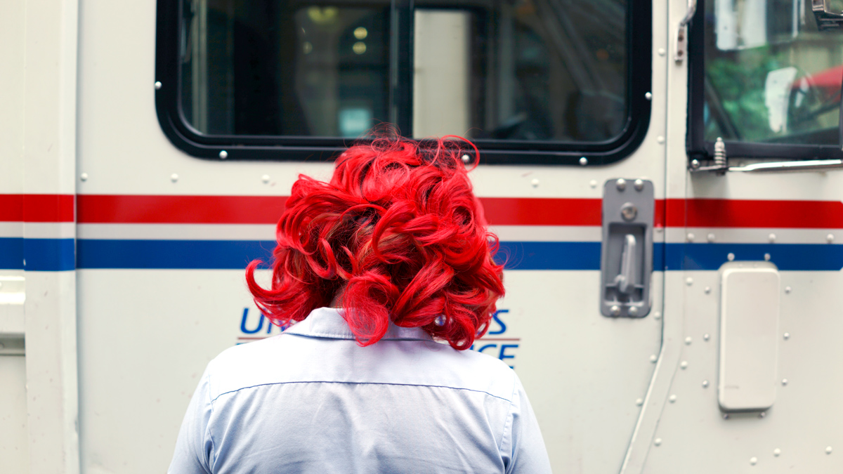 A UPS postal worker walks towards her truck in Manhattan, New York City